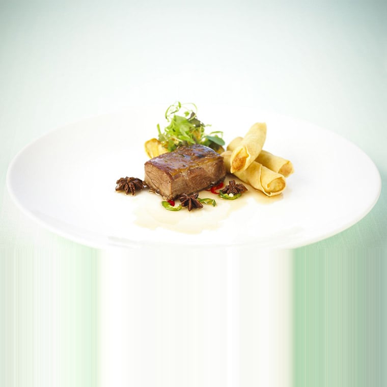 Glazed chai tea smoked lamb shoulder with vegetable spring rolls