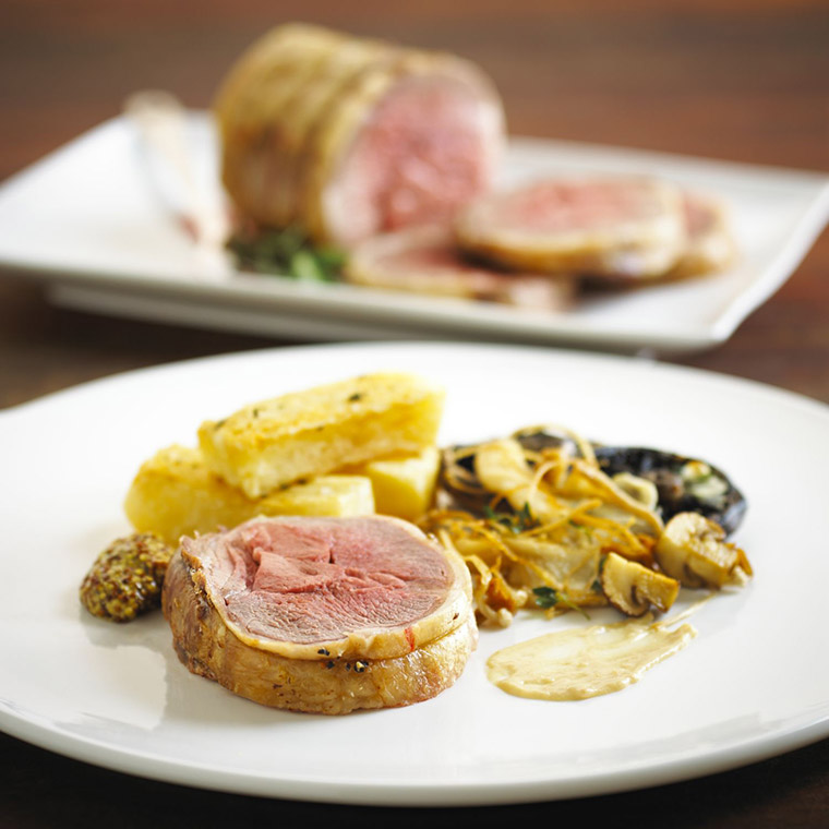 Roasted loin of lamb with thick cut fries and wild mushrooms